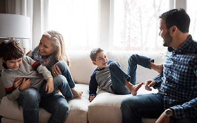 Image showing Love, bonding and family on the sofa for fun, playing and playful energy in their house. Relax, happy and parents with crazy children to play wrestle on the couch during quality time in a home