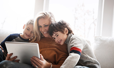 Image showing Love, brothers and mother with tablet, sofa and connection for social media, funny videos and bonding in lounge. Boys, motherhood and mama with device, online reading and learning in living room