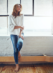 Image showing Thinking, fashion and window with a woman, barefoot in her home, standing next to mockup or flare. Motivation, idea and relax with an attractive young female leaning against a wall in her house