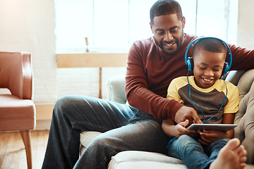 Image showing Tablet, relax and father with boy on a sofa watching a funny, comic or meme video on social media. Happy, smile and African man streaming a movie with child on mobile device while relaxing together.