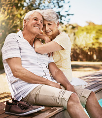 Image showing Senior couple, relax and smile by pool in love and summer vacation, bonding or quality time together in the outdoors. Happy elderly man and woman relaxing and hugging by the water at a poolside