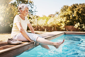 Image showing Relax, travel and senior woman by the pool while on a vacation, adventure or outdoor trip in summer. Happy, smile and elderly lady in retirement with her feet in the swimming pool at a holiday resort