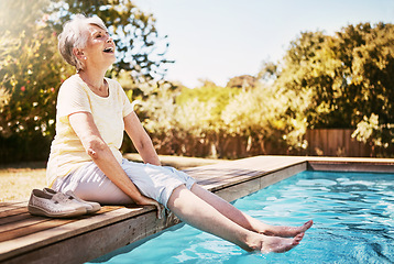 Image showing Elderly woman with her feet in the water of the pool while on a vacation, adventure or outdoor trip in summer. Happy, smile and senior lady in retirement relaxing by swimming pool at a holiday resort