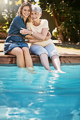 Image showing Women, hug and relax by swimming pool, love and care with quality time during summer vacation. Elderly mother, daughter and vacation, outdoor with pool and wellness lifestyle with happy family