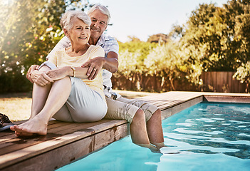 Image showing Senior couple, hug and relax by pool for love and summer vacation, bonding or quality time together in the outdoors. Happy elderly man and woman relaxing and hugging with feet in water by a poolside