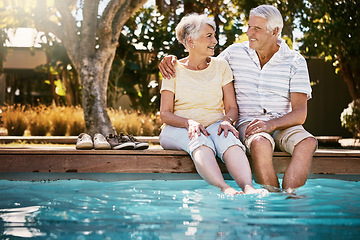 Image showing Senior couple, hug and swimming pool for holiday in relax for love or quality bonding time together on summer vacation. Happy elderly man holding woman relaxing with feet in water by the poolside