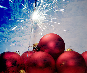 Image showing red christmas balls, fireworks and blue backrounds