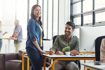 Image showing Business people, happy at computer and training, team and leader help with portrait in coworking space and writing notes. Man, woman and work, collaboration and partnership with advice and coaching