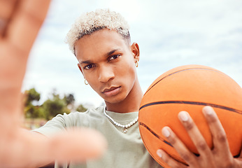 Image showing Sports, selfie and basketball player with fashion with a ball standing on an outdoor court. Fitness, edgy and cool man model and athlete from Brazil posing for a picture with a casual outfit in city