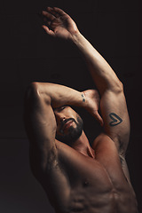 Image showing Man, body or muscle on black background in studio for fitness goals, workout or training motivation and healthcare wellness check. Bodybuilder, sports athlete or model flexing on aesthetic backdrop