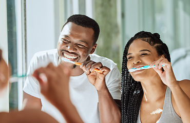 Image showing Brushing teeth, dental and oral hygiene with a black couple grooming together in the bathroom of their home. Health, tooth care and cleaning with a man and woman bonding during their morning routine