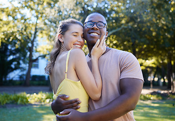 Image showing Love, interracial and couple hug in park, bonding and happiness for romance, wellness and quality time together. Romantic, black man and woman embrace, dating and loving for relationship and smile