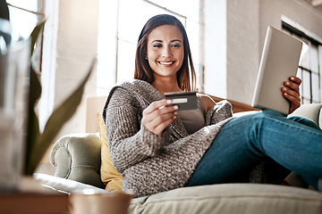 Image showing Online payment, digital tablet and credit card by woman on a sofa for online shopping in her home. Ecommerce, banking and girl with debit card for credit score, purchase or payment in living room