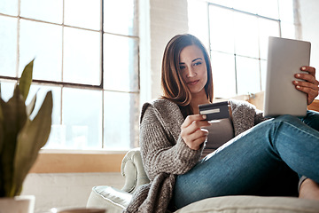 Image showing Digital tablet, credit card and woman on a sofa for online shopping, ecommerce and payment while relaxing. Girl, couch and online banking from app, purchase and booking online in a living room