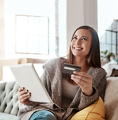 Image showing Thinking, credit card and online shopping on digital tablet by woman on sofa for payment or booking online. Idea, girl and online banking with debit card for credit score, purchase and online order