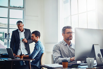 Image showing Office building, working on computer and business people at table with manager, planning and email. Corporate workplace, teamwork and employees sitting at desk, in meeting and coworking on ideas