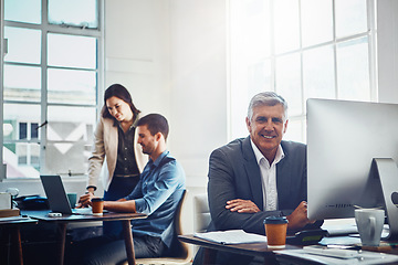 Image showing Senior, portrait and business man by computer in office workplace. Pc, coworking and happy elderly male employee working on marketing report, advertising or sales project with colleagues in company.