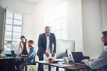 Image showing Leadership, teamwork and portrait of business man in office workplace. Coworking, ceo and senior male employee working on marketing report, advertising or sales project with colleagues in company.