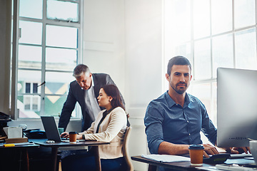 Image showing Portrait, office and business man by computer in company workplace. Pc, typing and serious male employee ready for working on marketing report, advertising proposal or sales project with colleagues.