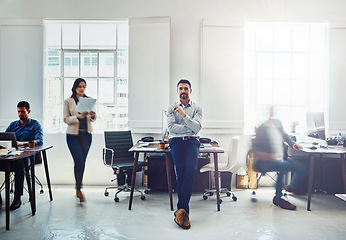 Image showing Man, leader and office portrait with business group, sitting and desk with confidence for success. Manager, leadership and focus with staff, teamwork or group for goal, company vision and marketing