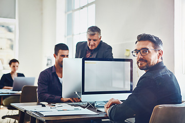 Image showing Office, portrait and business man by computer in company workplace. Planning, coworking or mature male employee on pc working on marketing report, advertising proposal or sales project with coworkers