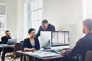 Image showing Office, coaching and business people training with computer. Mentor, teamwork and collaboration of employees, woman and mature man on pc working on advertising, marketing or sales project in company.