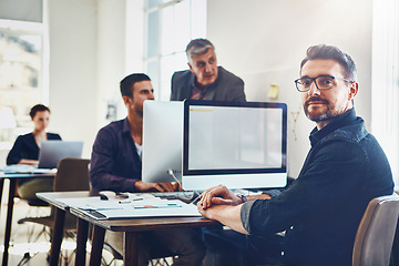 Image showing Portrait, mature and business man by computer in office workplace. Planning, pc or confident male employee working on marketing report, advertising proposal or sales project with coworkers in company