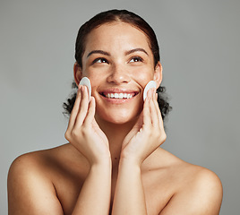 Image showing Skincare, beauty and woman with cotton pad for face glow, cleaning and dermatology on a grey studio background. Spa, cosmetology and model with product for facial clean, body health and acne