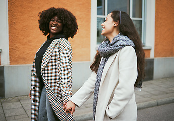 Image showing Love, holding hands and lesbian couple walking in street enjoying holiday, vacation and adventure on weekend. Fashion, lgbtq relationship and women together for happy lifestyle, freedom and relaxing