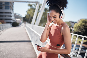 Image showing Music headphones, fitness and black woman with phone for social media in city. Exercise, sports and female athlete streaming radio or podcast on 5g mobile smartphone after training outdoors on street