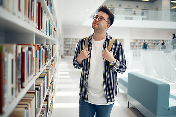 Image showing Library bookshelf, student and search for university, college or school books for research, learning and knowledge. Study, reading print and geek man with backpack for history, language or philosophy