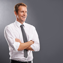 Image showing Idea, vision and mindset with a business man in studio on a gray background for advertising or marketing. Thinking, growth or future mission with a handsome male employee arms crossed next to mockup