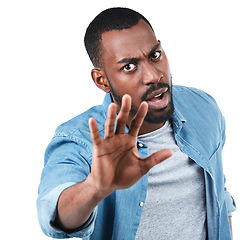 Image showing Portrait, hand and man in studio for stop, sign and warning while standing against white background. Face, hand gesture and palm, protest and defense, fight and denial, no and reject while isolated