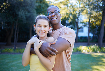 Image showing Couple in portrait, date in park with hug and outdoor in nature, love and commitment with interracial relationship. Trust, support and happy people, black man and woman smile on face with fresh air