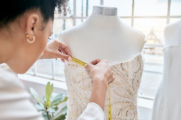 Image showing Fashion, designer and woman measuring dress on mannequin. Small business, boutique and female seamstress or tailor with tape to measure clothing, fabric or textile on dummy in workshop or studio.