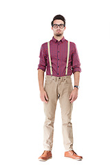 Image showing Portrait, nerd and man serious, fashion and glasses with young person isolated on white studio background. Gentleman, male and hipster with funky outfit, smart guy and suspenders with confidence