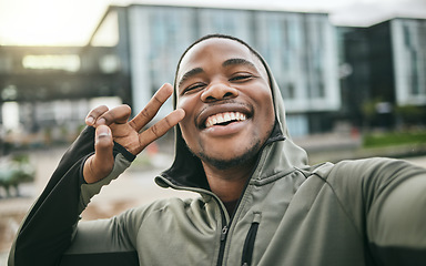 Image showing Fitness, selfie and man with peace sign in the city while doing a cardio exercise in Nigeria. Happy, smile and Nigerian guy taking picture while running for sports, race or marathon training in town.