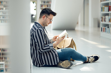 Image showing Man, student and reading in library with book for knowledge, education or learning at the university. Male learner in study with books for thesis, project or assignment for scholarship at the campus