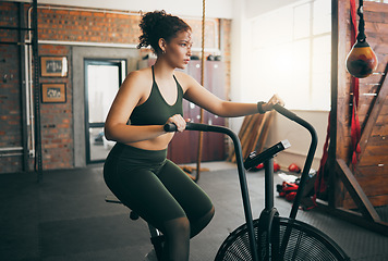 Image showing Exercise bike, fitness and woman at gym for workout, cardio training and cycling for energy, balance and lose weight. Sports female or athlete with spinning machine for health, wellness and self care