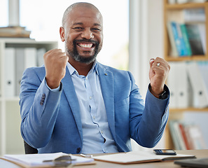 Image showing Success, winner and businessman at his desk in office for company profit, stock market or financial increase, promotion or bonus. Happy news, fist and winner corporate black man in a career portrait