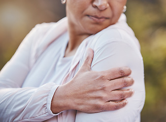 Image showing Senior woman, sports injury and shoulder pain at park after accident. Wellness, health and hand of elderly female on arm with muscle inflammation or fibromyalgia after exercise or training outdoors.