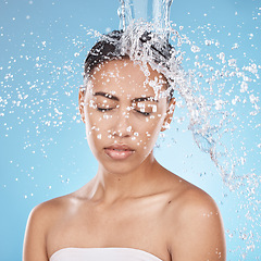 Image showing Woman, washing hair or water splash skincare on blue background studio in healthcare wellness, dermatology grooming or hygiene cleaning. Beauty model, wet or water drops in bathroom shower hair care