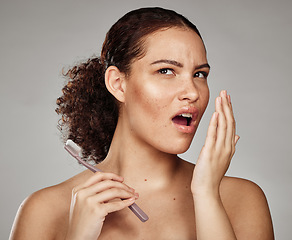 Image showing Woman, bad breath and smelling mouth for dental problem, odor and poor oral health in hand. Female with toothbrush for brushing teeth and self care for halitosis, cavity or decay on grey background