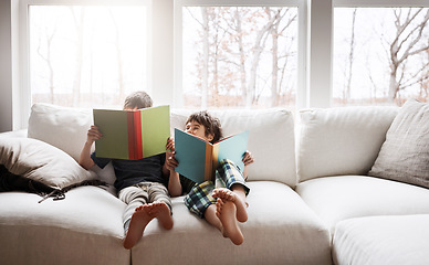 Image showing Kids, bonding reading books in education, learning or relax studying on house living room or family home sofa. Happy children, storytelling or fantasy fairytale novel in hobby or creative inspiration