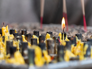 Image showing Single candle burning at Buddhist temple in Thailand