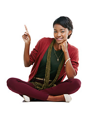 Image showing African woman, happy portrait and pointing finger, relax sitting isolated in white background for advertising mockup. Black woman, smile and point for marketing, product placement or idea vision