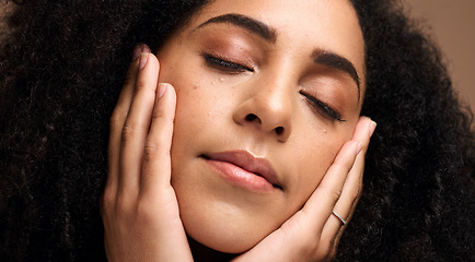 Image showing Beauty, face and skincare with a model black woman touching her skin in studio on a brown background. Peace, wellness and relax with an attractive young female posing with her hands on her cheeks