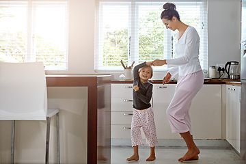 Image showing Kitchen dance, mom and girl in the morning at home with happiness dancing together. Mom, child and mama care holding hands with a young kid in a house happy about funny family with a smile