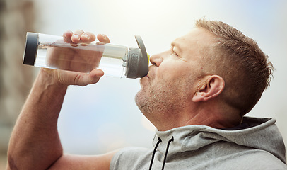 Image showing Fitness, runner or man drinking water with sports performance goals resting or relaxing on break. Healthy, tired or thirsty athlete drinks natural liquid in cardio workout, training or body exercise