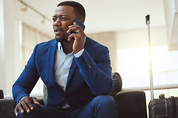 Image showing African man in hotel, on business call and listening to voice message in Chicago for work travel. Corporate professional, young black entrepreneur talking on smartphone and luxury airport building